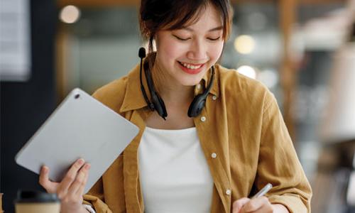 A girl working on home work with a tablet